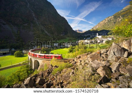 Similar – Image, Stock Photo Train on bridge amid lush plants in mountains