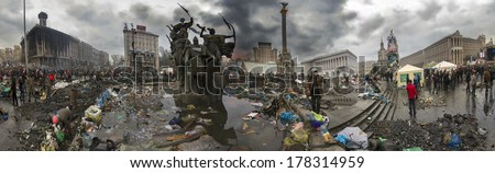 Kiev, Ukraine - February 20, 2014: Freed from government troops Evromaydan. The smoke protesters hiding from snipers, collecting stones and bottles at the devastated area to the forward position