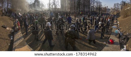 Kiev, Ukraine - February 20, 2014: Freed from government troops Evromaydan.   The smoke protesters hiding from snipers, passing stones and bottles at the devastated area to the forward position