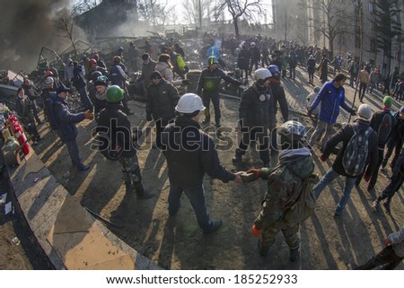 Kiev, Ukraine - February 20, 2014: Freed from government troops Evromaydan. The smoke protesters hiding from snipers, collecting stones and bottles at the devastated area to the forward position,