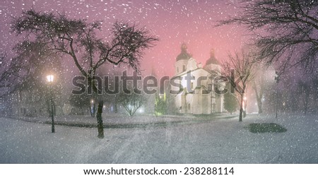 Blizzard and rain enveloped Kiev, bad weather a bad review -  ancient St. Sophia Cathedral, background of the ancient walls and trees bashen- monastic park and garden, beautiful illumination at night