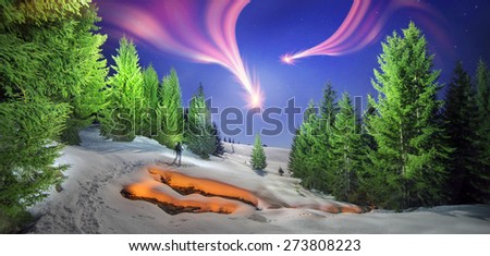 Night air travelers traveler walk with fire on the frozen forest for original photographs of wildlife in the wild Carpathian gorge with clean cold creek on a background of the sky