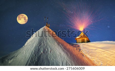 Beautiful wild Carpathian ridge - Montenegro, on the background of a powerful lantern-lit building - a refuge from snow bricks protecting tent extreme sportsmen from wind and frost
