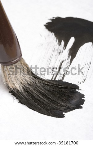 Close-up shot of an Asian traditional writing brush and a calligraphy