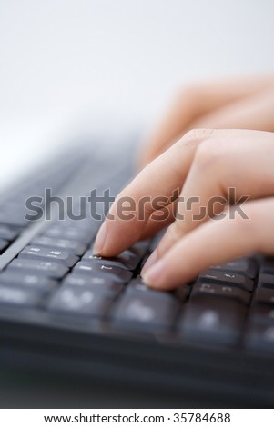 BUSINESS IMAGE- close-up shot of woman\'s fingers typing the black keyboard