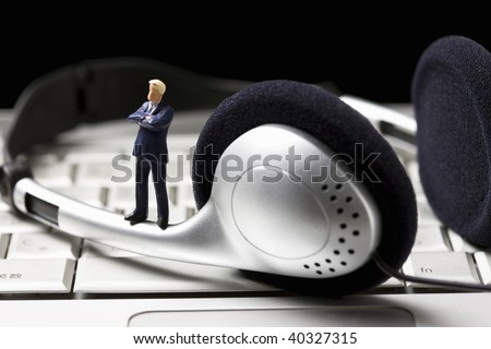 Big earphones and the businessman who pauses on the keyboard.
