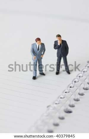 Figures of the businessman who lines up on the notebook.