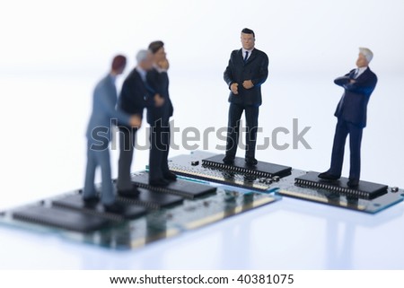 Figures of the businessman who communicates on the computer chip.