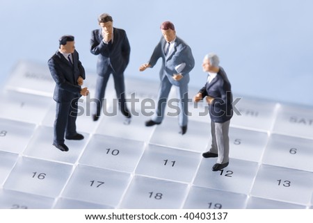 Doll of the businessman who communicates on the schedule.