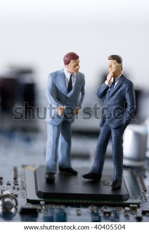 Dolls of the businessman who communicates in the electronic machine.