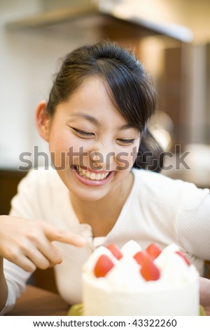 A smiling young woman with cake