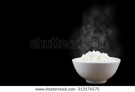 Isolated of Hot Steamed Rice in a White Bowl with White Vapor on dark background