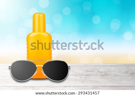 sun lotion with sunglasses and a beach background