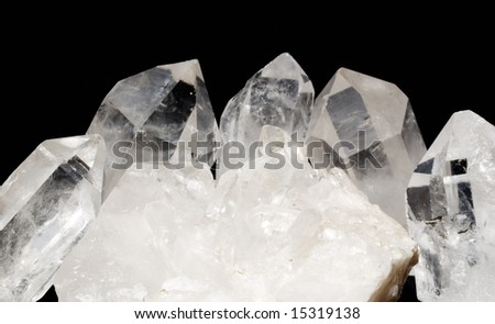 Druze of quartz crystals with quarts crystals laid on black textile. Druzes are used in esoteric for energizing other gems and also in alternative medicine.