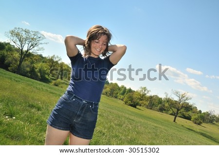 Woman enjoying life outdoors in green sunny park (pleasure expression)