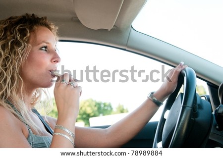 Young person eating sweets while driving car