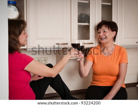 Happy life - mother and daughter drinking wine