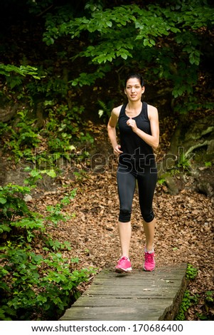 Running for health - young woman jogging in nature