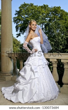 Beautiful, elegant bride standing in magnificent italian manor