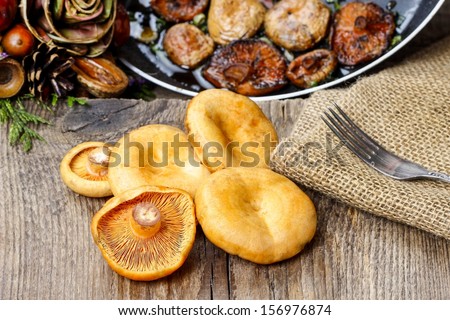 Saffron milk cap mushrooms on wooden table