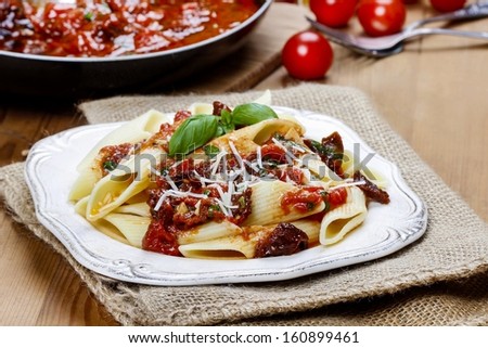 Penne with dried tomatoes. Italian cuisine, delicious, popular dish.