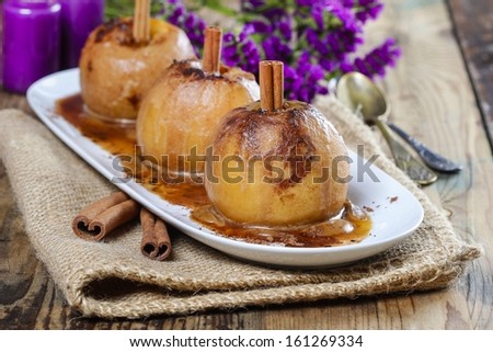 Apples with cinnamon on jute napkin. Sea lavender in the background. Healthy autumn dessert.