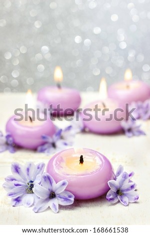 Scented candles and violet hyacinth flowers