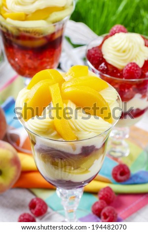 Layer fruit desserts on wooden tray. Summer garden party