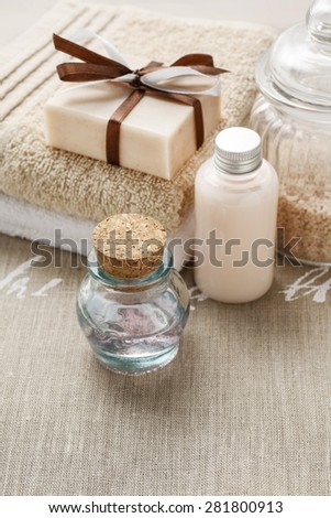 Bar of handmade soap, bottle of essential oil and bottle of liquid soap