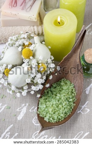 Bowl of green sea salt and scented candles