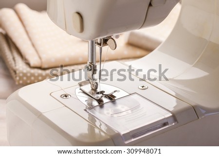 Sewing machine and fabrics in the background