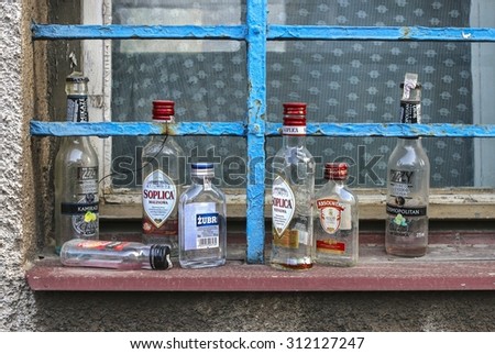 KRAKOW,POLAND - JULY 27, 2015: Empty vodka bottles at the window sill.