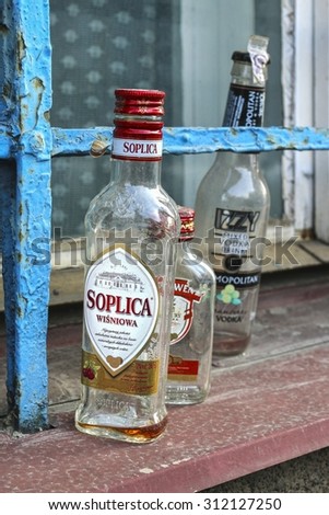 KRAKOW,POLAND - JULY 27, 2015: Empty vodka bottles at the window sill.