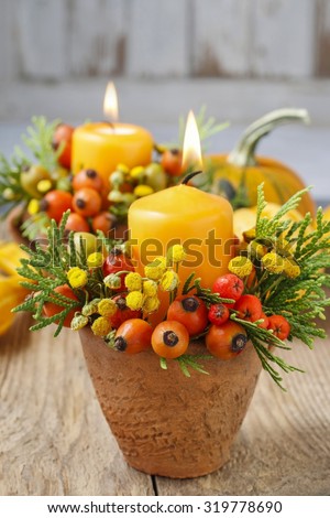 Beautiful decoration with candle and autumn plants. Table decor.