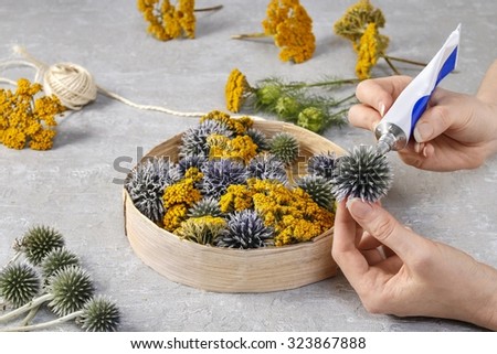 Florist at work: how to make floral decoration with wild plants in round box. Step by step, tutorial.