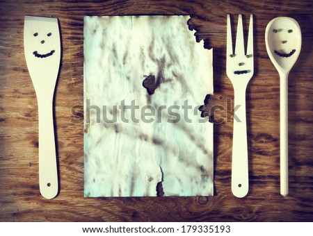 old paper with kitchenware on wooden table.vintage photo concept