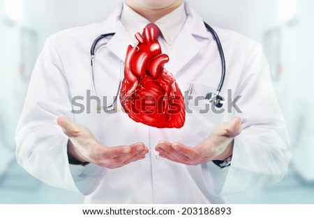 Doctor with heart in hands in a hospital
