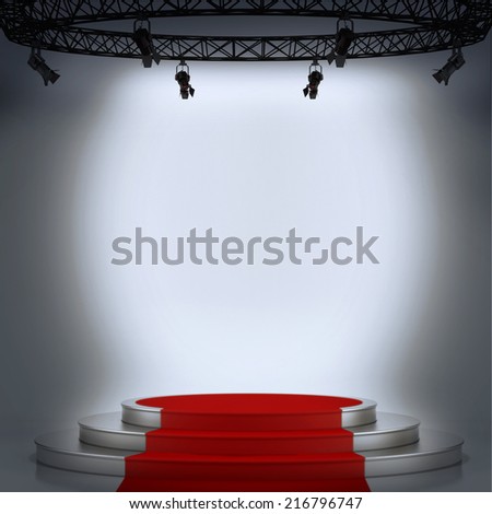 Illuminated stage podium with red carpet for award ceremony