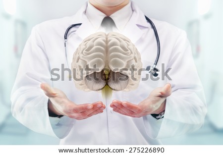Doctor with stethoscope and brains on the  hands in a hospital. High resolution.
