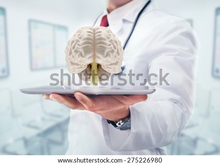Doctor with stethoscope and brains on the tablet in the hands in hospital..High resolution.