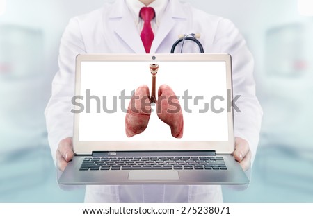 Doctor with stethoscope in a hospital. lungs on the laptop monitor. High resolution.