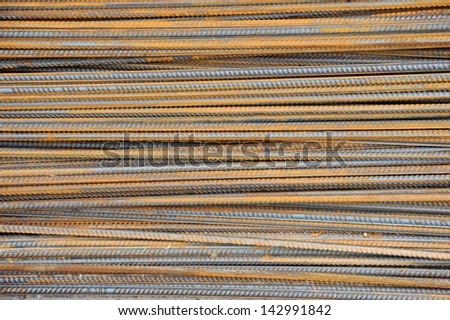 steel or iron rods or bars used to reinforce concrete