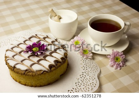 An afternoon tea theme - sweet food - cake, sugar and flowers in beige and pink - coziness.
