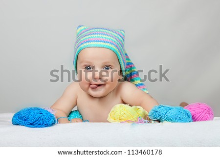 Similar – Image, Stock Photo Curious beautiful baby boy in blue body lying on playing mat, looking in the camera