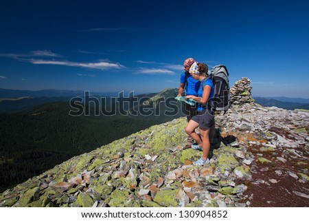 Portrait of couple at the top of the mountain that search for the path