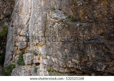 Man practices in climbing at the rock in the Crimea mountains