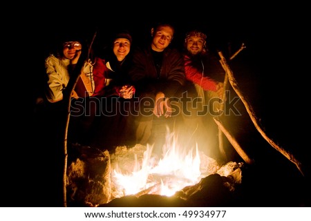 People near campfire in forest