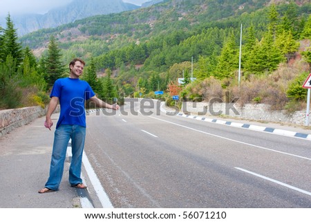 Man Hitchhiking On A Country Road