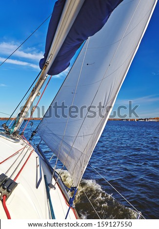 Sailboat in action, extreme sport, autumn cruise on the lake, active lifestyle