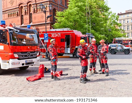 Torun, Poland - May 06, 2014: Firemen shows mountaineering training during Fire Service Day celebration at square Rynek Staromiejski  in Torun, Poland